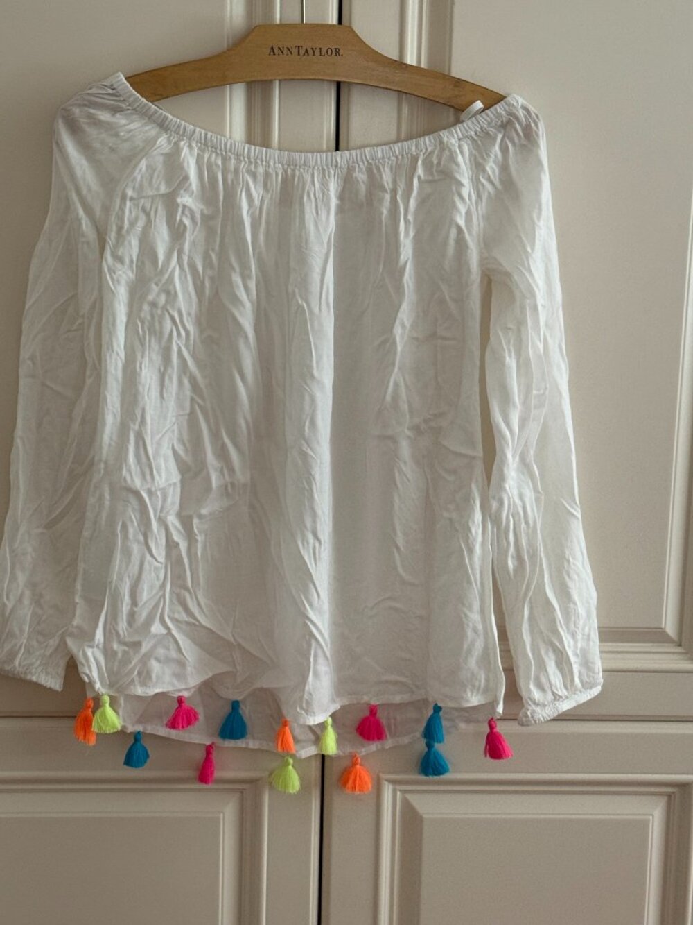 white tunic with colorful tassels